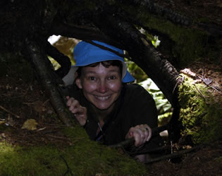 Annette in the roots of a tree